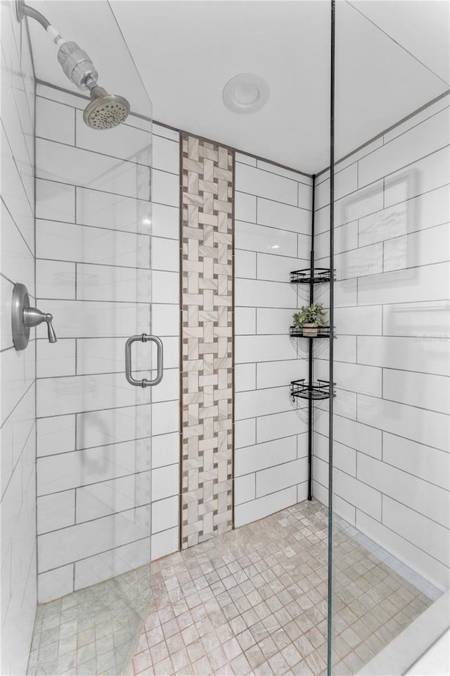 bathroom featuring a shower with door