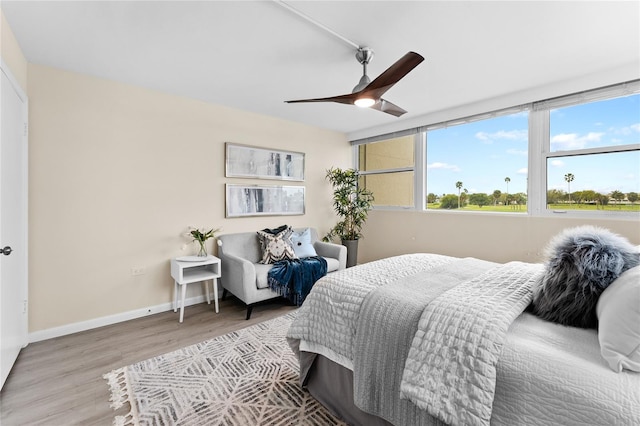 bedroom with light hardwood / wood-style floors and ceiling fan