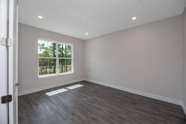 spare room with dark wood-type flooring