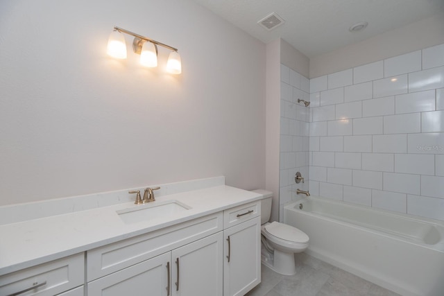 full bathroom featuring toilet, vanity, and tiled shower / bath