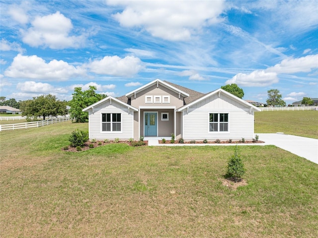 single story home with a front yard and covered porch