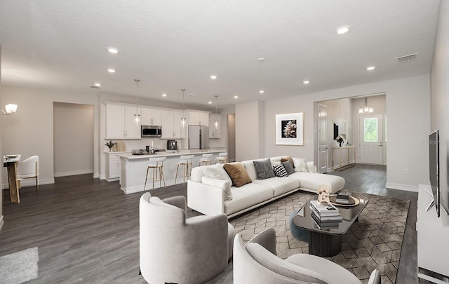 living room featuring hardwood / wood-style flooring and a textured ceiling