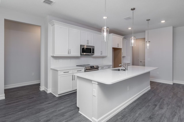 kitchen with white cabinetry, a center island with sink, sink, and appliances with stainless steel finishes