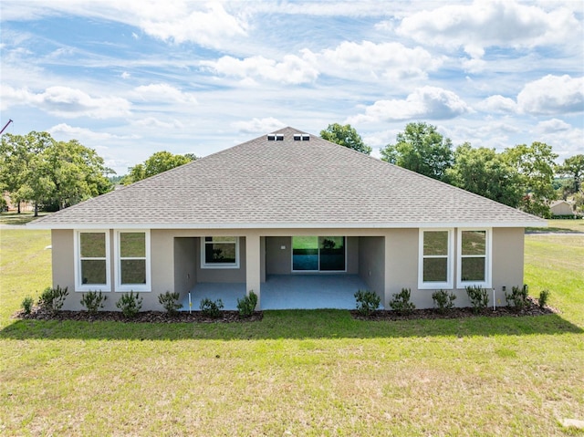 ranch-style house with a front lawn and a patio