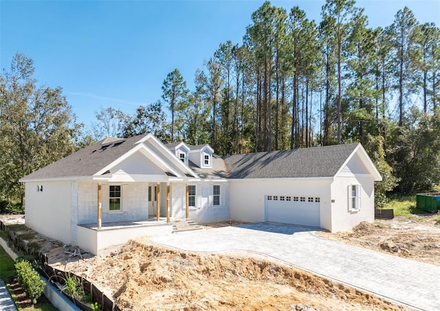 view of front of house with a garage and a porch