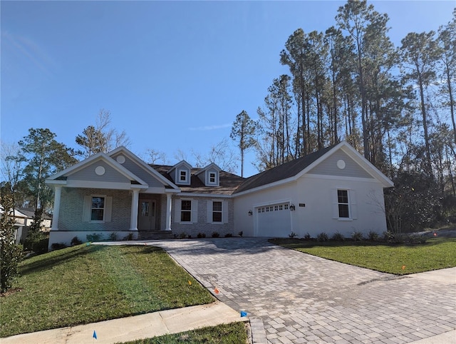 view of front of home featuring a porch, a garage, and a front yard