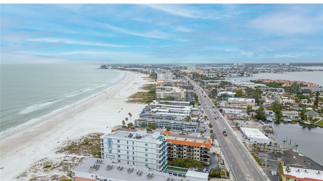 drone / aerial view featuring a water view and a view of the beach