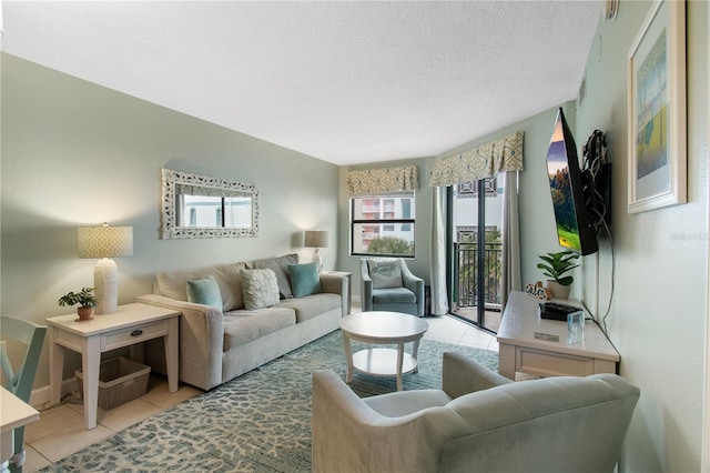 living room with a textured ceiling and light tile patterned floors