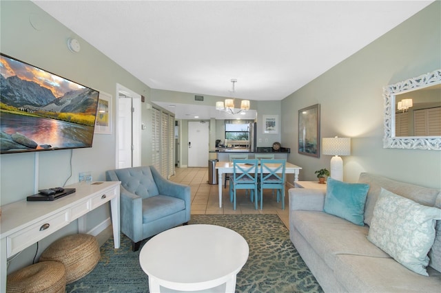 living room featuring a notable chandelier and tile patterned flooring