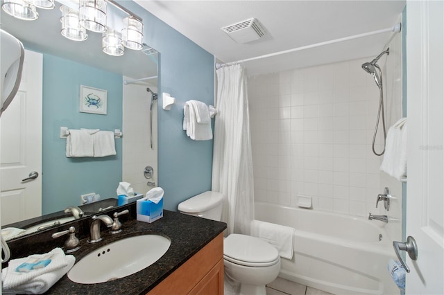 full bathroom featuring shower / bath combo with shower curtain, vanity, tile patterned floors, and toilet