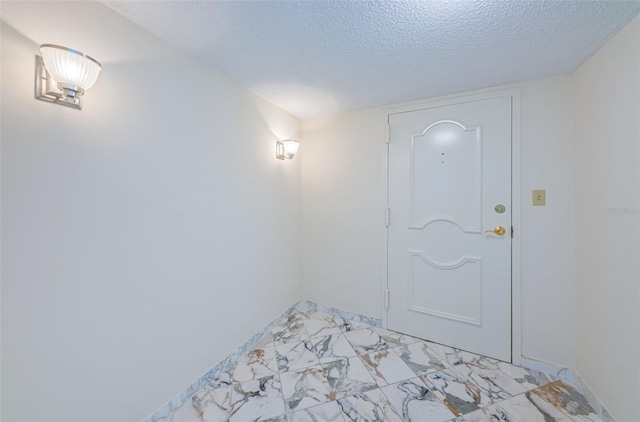 entryway with a textured ceiling