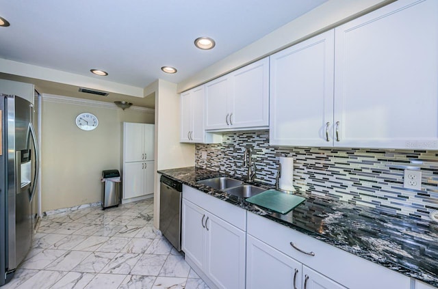 kitchen featuring dark stone countertops, sink, white cabinets, and appliances with stainless steel finishes