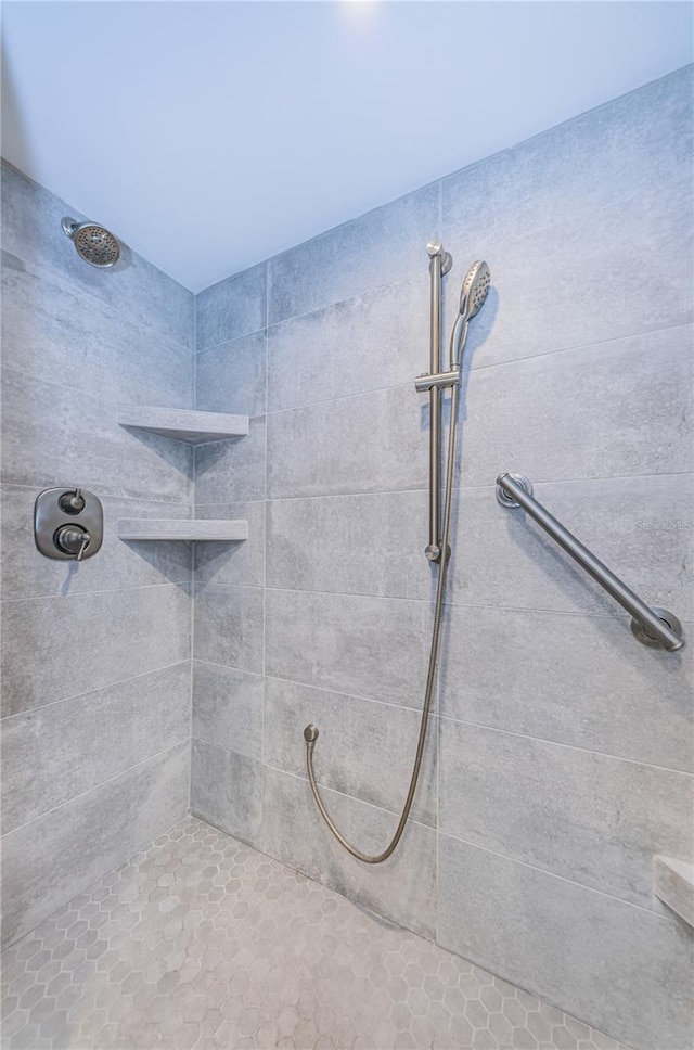 bathroom with tiled shower