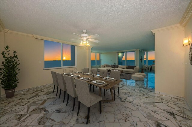 dining space with ceiling fan, ornamental molding, and a textured ceiling