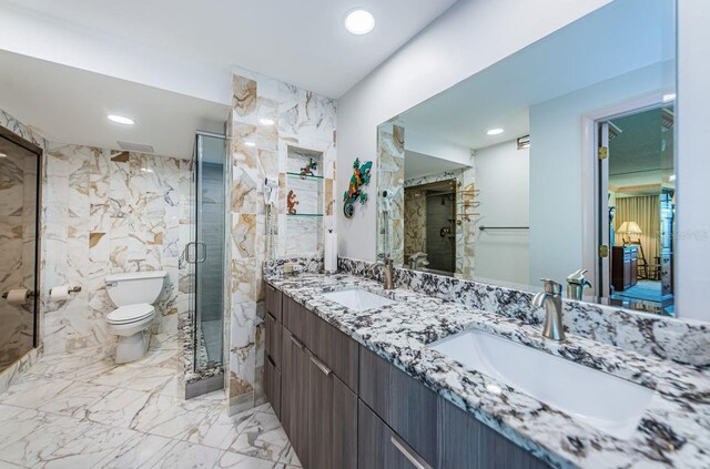 bathroom with walk in shower, vanity, and toilet