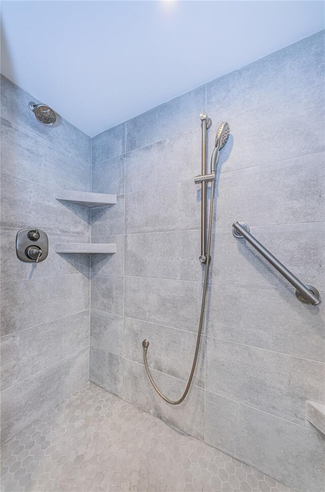 bathroom with a tile shower