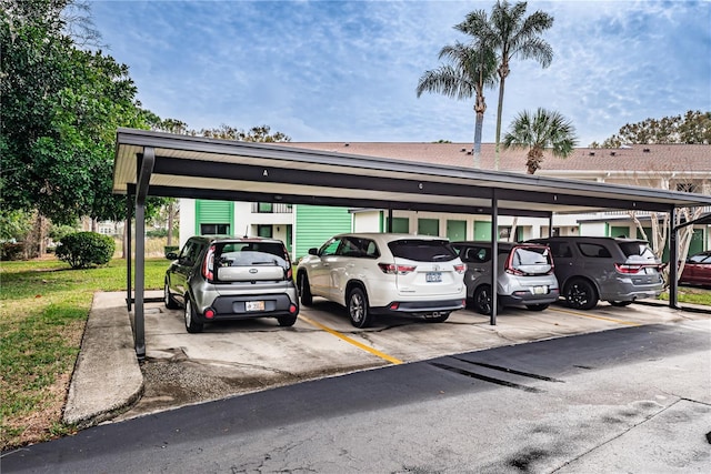 view of car parking with a lawn and a carport