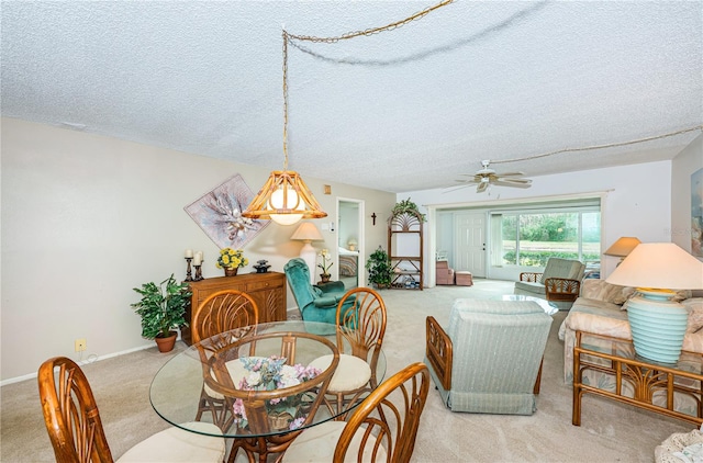 dining space with light carpet, a textured ceiling, and ceiling fan