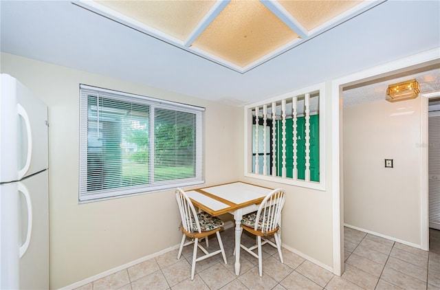 dining space featuring light tile flooring