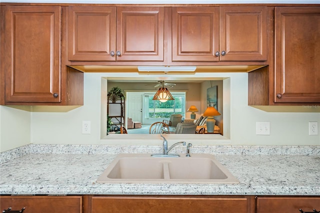 kitchen with light stone countertops and sink