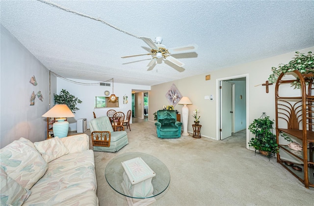 carpeted living room featuring radiator, ceiling fan, and a textured ceiling