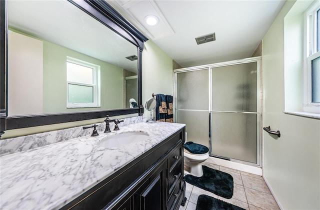 bathroom with vanity, tile floors, a shower with shower door, and toilet