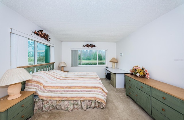 carpeted bedroom featuring a textured ceiling