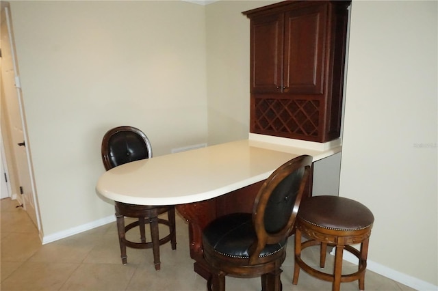 dining space featuring light tile patterned floors