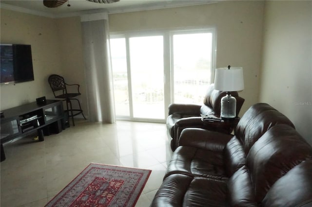 tiled living room with ceiling fan and ornamental molding