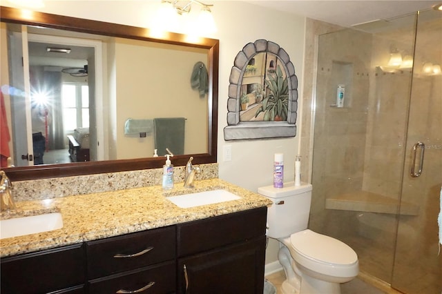 bathroom with vanity, toilet, and an enclosed shower