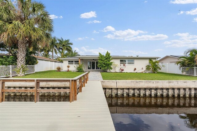 dock area featuring a yard and a fenced backyard