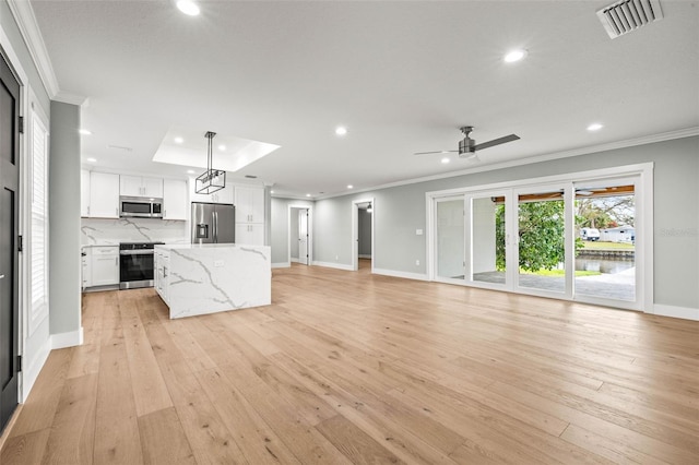 unfurnished living room with visible vents, crown molding, and light wood finished floors