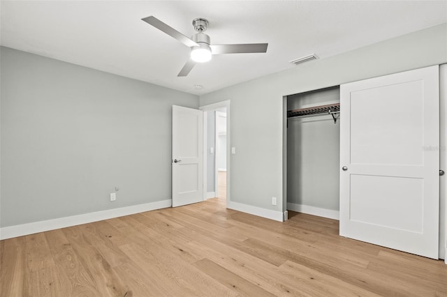 unfurnished bedroom with light wood finished floors, baseboards, visible vents, and a closet