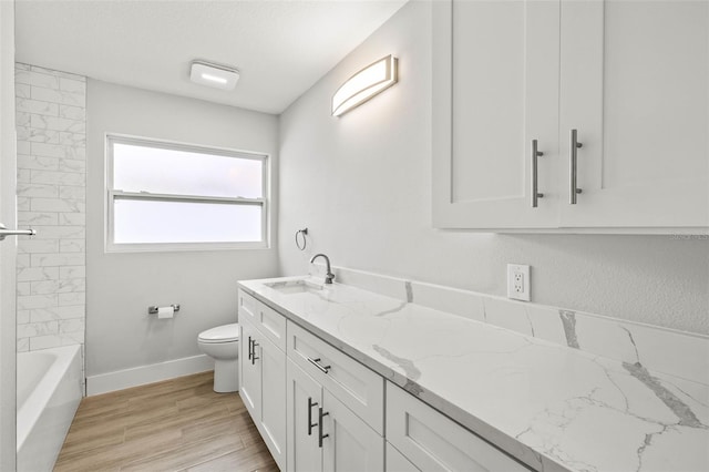 full bath with baseboards, toilet, wood finished floors, a textured ceiling, and vanity