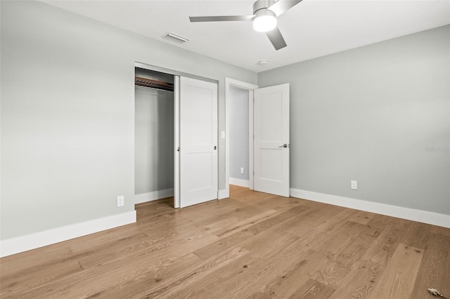 unfurnished bedroom featuring a closet, baseboards, visible vents, and light wood finished floors