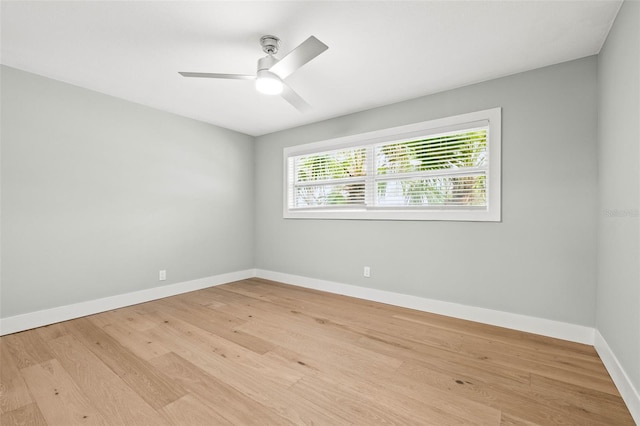 unfurnished room featuring baseboards, ceiling fan, and light wood-style floors