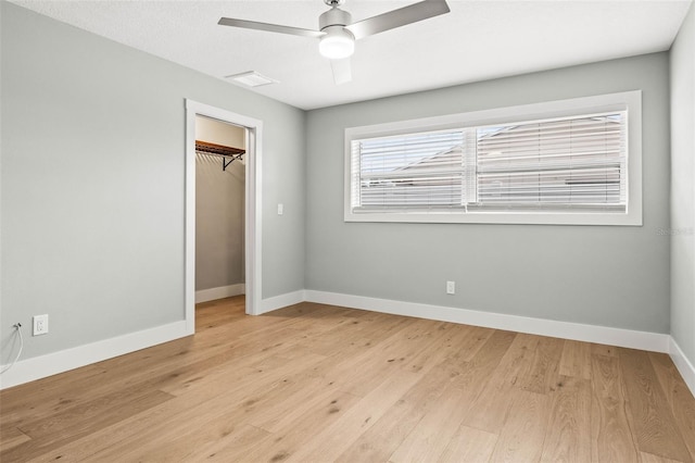 unfurnished bedroom with visible vents, baseboards, ceiling fan, light wood-type flooring, and a closet