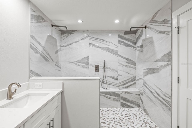 full bathroom with recessed lighting, a marble finish shower, and vanity