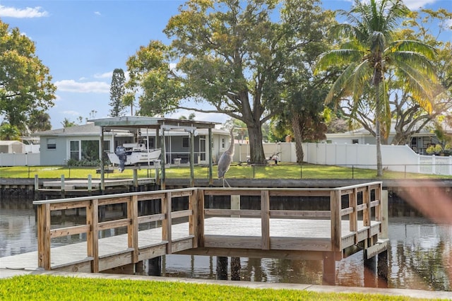 view of dock featuring a water view, fence, and a yard