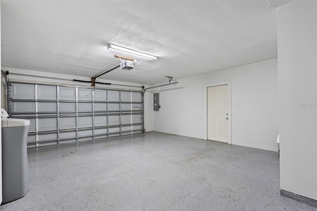 garage with electric panel and a garage door opener