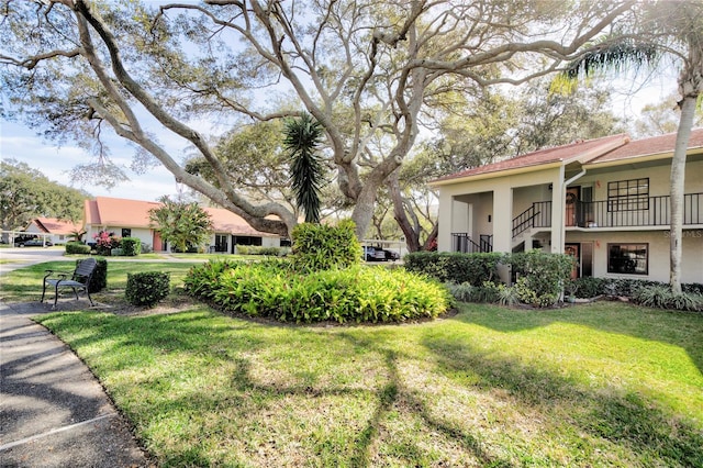 view of home's community featuring a lawn