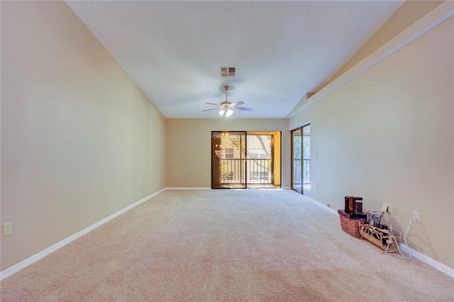 empty room with ceiling fan, carpet flooring, and a textured ceiling