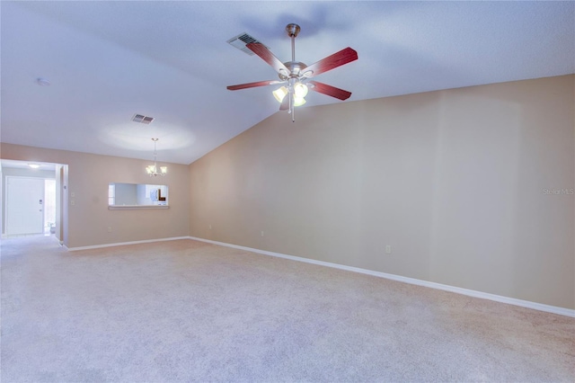 carpeted spare room with lofted ceiling and ceiling fan with notable chandelier