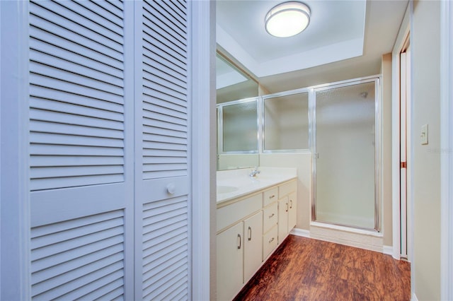 bathroom with vanity, hardwood / wood-style floors, and a shower with shower door