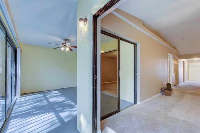 corridor featuring vaulted ceiling and carpet