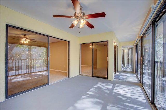 interior space featuring access to exterior and ceiling fan