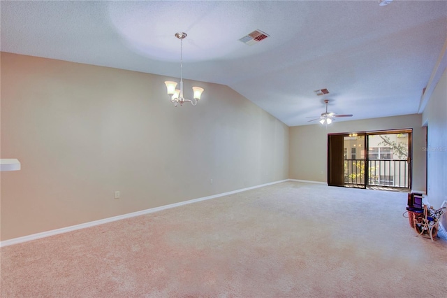 spare room with lofted ceiling, ceiling fan with notable chandelier, carpet, and a textured ceiling