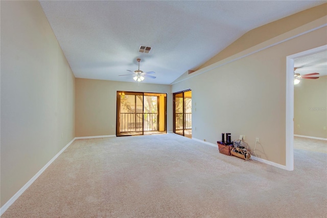 unfurnished room with vaulted ceiling, carpet floors, and ceiling fan