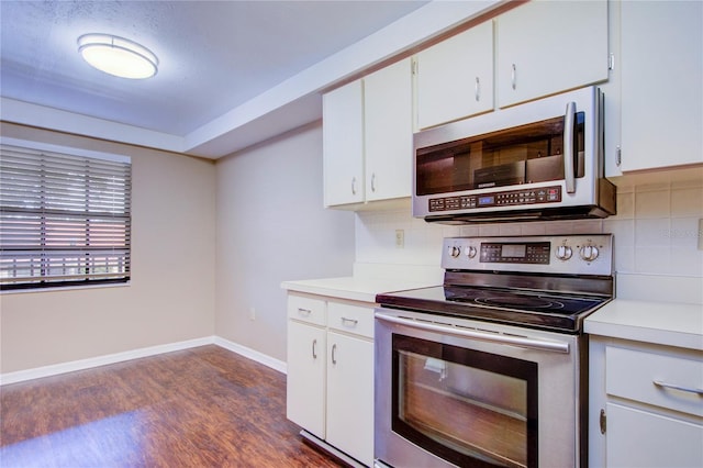 kitchen featuring white cabinetry, decorative backsplash, stainless steel appliances, and dark hardwood / wood-style floors