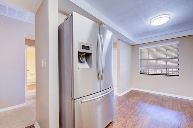 kitchen featuring stainless steel refrigerator with ice dispenser and wood-type flooring